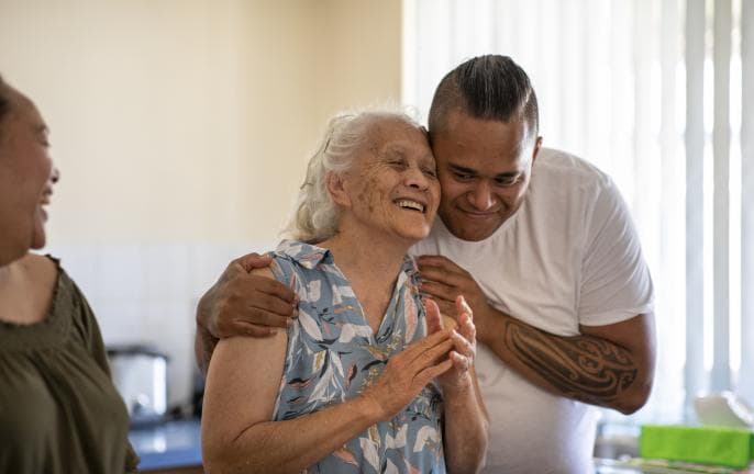 younger man embracing older woman